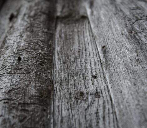 Wall of old wooden boards in natural color. Selective focus.